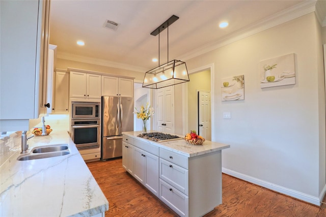 3628 Timberside Circle Dr, Houston, TX 77025 - kitchen with appliances with stainless steel finishes, a sink, ornamental molding, light stone counters, and a center island