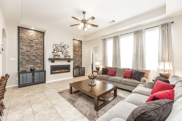 19315 S Cottonwood Green Ln, Cypress, TX 77433 - living room with arched walkways, a ceiling fan, light tile patterned flooring, a glass covered fireplace, and recessed lighting