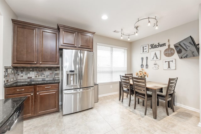 19315 S Cottonwood Green Ln, Cypress, TX 77433 - kitchen with stainless steel appliances, decorative backsplash, baseboards, dark stone countertops, and dark brown cabinetry