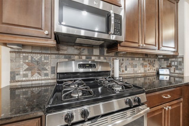 19315 S Cottonwood Green Ln, Cypress, TX 77433 - kitchen with stainless steel appliances, tasteful backsplash, dark stone counters, and brown cabinets