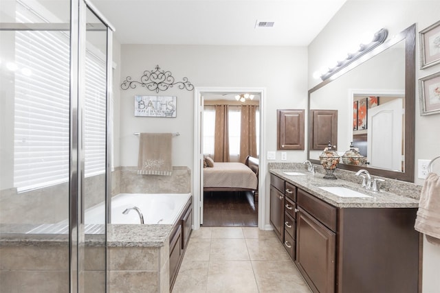19315 S Cottonwood Green Ln, Cypress, TX 77433 - bathroom with tile patterned flooring, double vanity, a bath, and connected bathroom