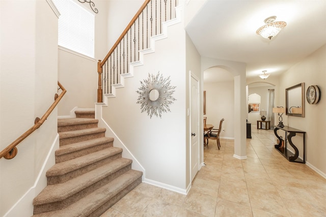 19315 S Cottonwood Green Ln, Cypress, TX 77433 - stairway with arched walkways, tile patterned floors, and baseboards