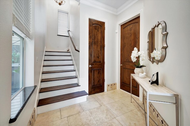 2010 Sabine St, Houston, TX 77007 - foyer entrance featuring crown molding, stairway, and light tile patterned floors