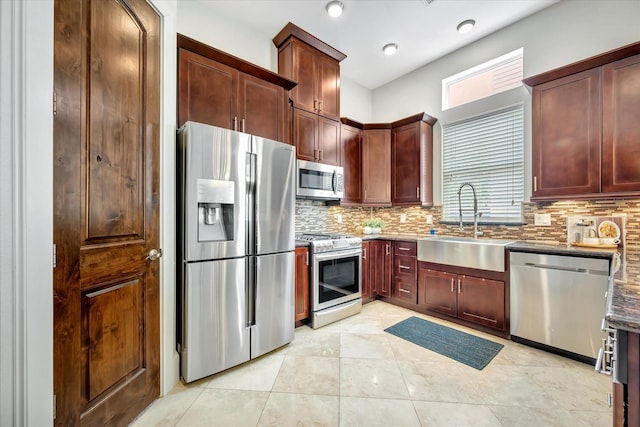 2010 Sabine St, Houston, TX 77007 - kitchen with appliances with stainless steel finishes, a sink, decorative backsplash, and healthy amount of natural light