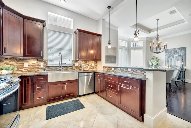 2010 Sabine St, Houston, TX 77007 - kitchen with stainless steel appliances, a sink, a peninsula, tasteful backsplash, and stone counters
