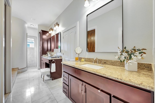 2010 Sabine St, Houston, TX 77007 - bathroom with vanity and marble look tile flooring