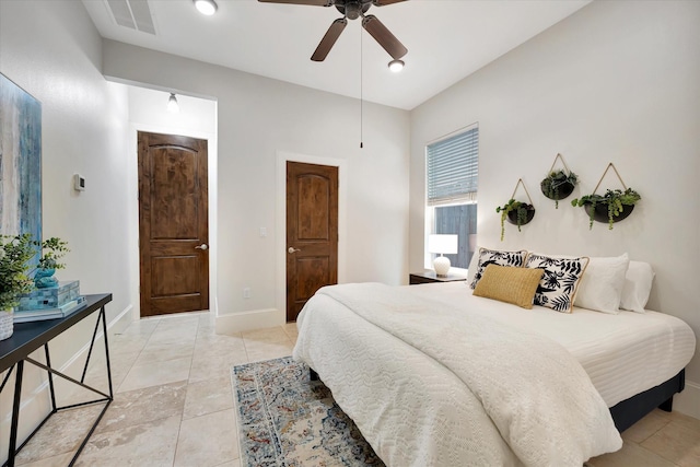 2010 Sabine St, Houston, TX 77007 - bedroom with ceiling fan, light tile patterned floors, and baseboards