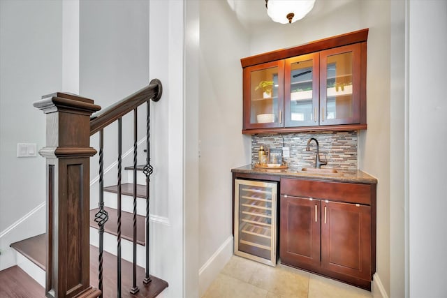 2010 Sabine St, Houston, TX 77007 - indoor wet bar with wine cooler, decorative backsplash, baseboards, light tile patterned floors, and stairs