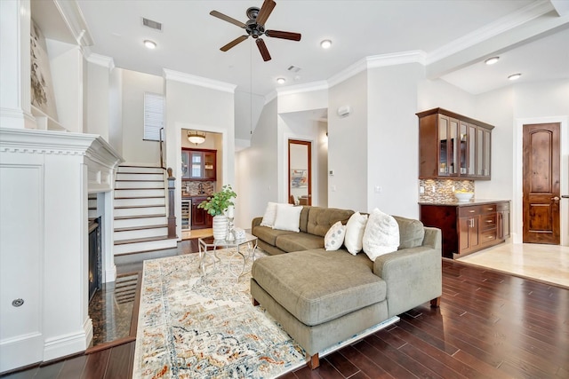2010 Sabine St, Houston, TX 77007 - living area featuring wood finished floors, a ceiling fan, ornamental molding, a warm lit fireplace, and recessed lighting