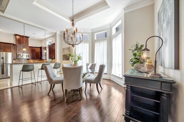 2010 Sabine St, Houston, TX 77007 - dining space with a chandelier, a raised ceiling, dark wood-style floors, ornamental molding, and baseboards