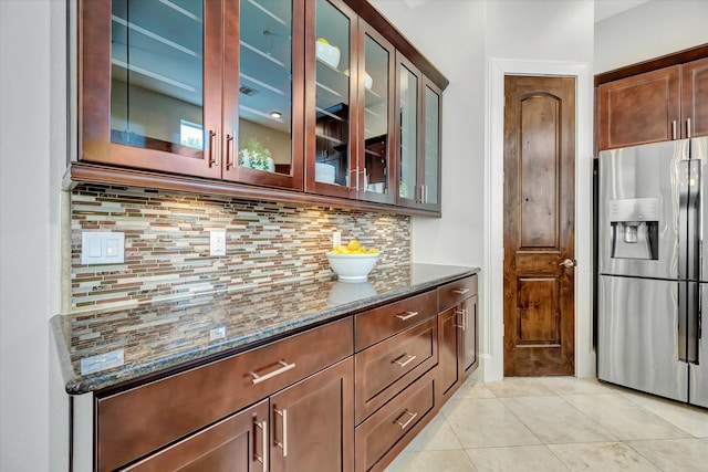 2010 Sabine St, Houston, TX 77007 - bar featuring stainless steel fridge with ice dispenser, backsplash, and light tile patterned floors