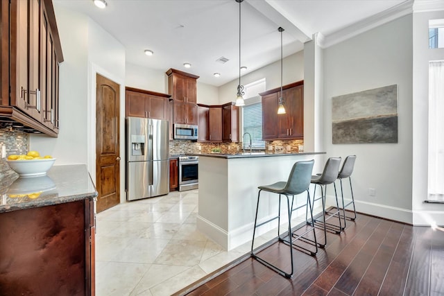 2010 Sabine St, Houston, TX 77007 - kitchen with stainless steel appliances, a peninsula, tasteful backsplash, pendant lighting, and recessed lighting