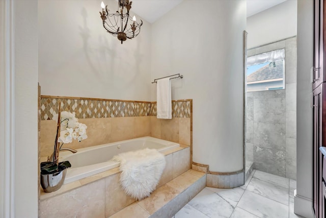 2010 Sabine St, Houston, TX 77007 - bathroom featuring a garden tub, a chandelier, marble look tile flooring, and a shower