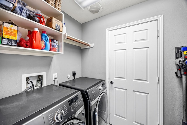 washroom with washing machine and clothes dryer