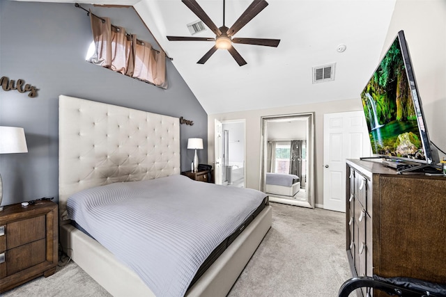 bedroom with light colored carpet, lofted ceiling, ceiling fan, and connected bathroom
