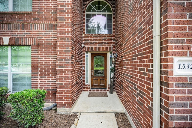 doorway to property with brick siding