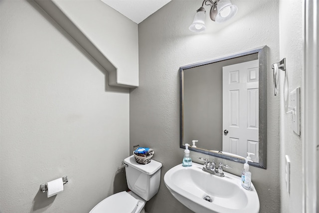 half bath with a sink and toilet