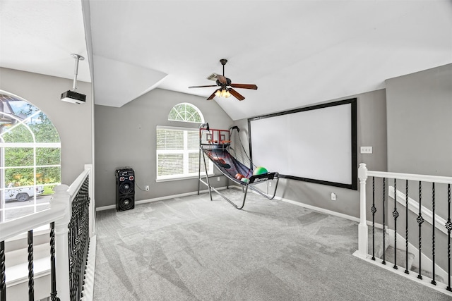 rec room with a ceiling fan, carpet flooring, vaulted ceiling, and baseboards