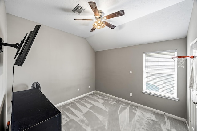 exercise room featuring a ceiling fan, carpet, baseboards, and lofted ceiling