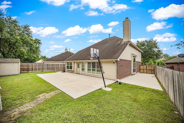 rear view of house with a patio, a chimney, an outbuilding, a storage shed, and brick siding