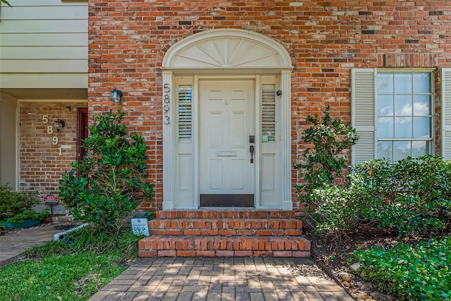 property entrance with brick siding
