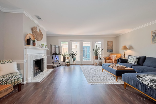 living room featuring dark wood-style floors, crown molding, and a premium fireplace