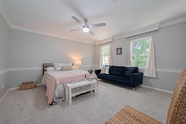 carpeted bedroom with ornamental molding, ceiling fan, and baseboards