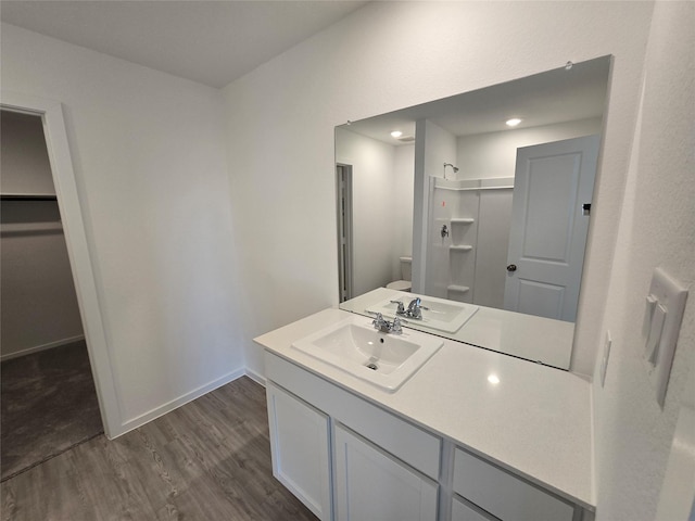 444 Shoreview Dr, Conroe, TX 77303 - bathroom featuring toilet, wood finished floors, vanity, baseboards, and a shower