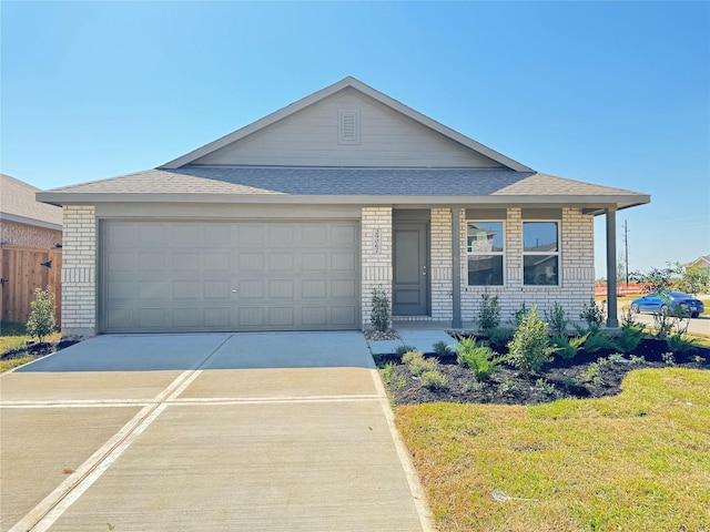 444 Shoreview Dr, Conroe, TX 77303 - view of front of house featuring brick siding, a shingled roof, an attached garage, concrete driveway, and a front yard