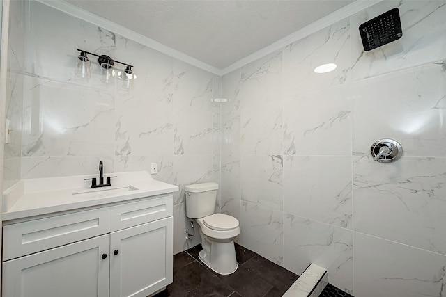 bathroom featuring ornamental molding, a tile shower, tile walls, vanity, and toilet