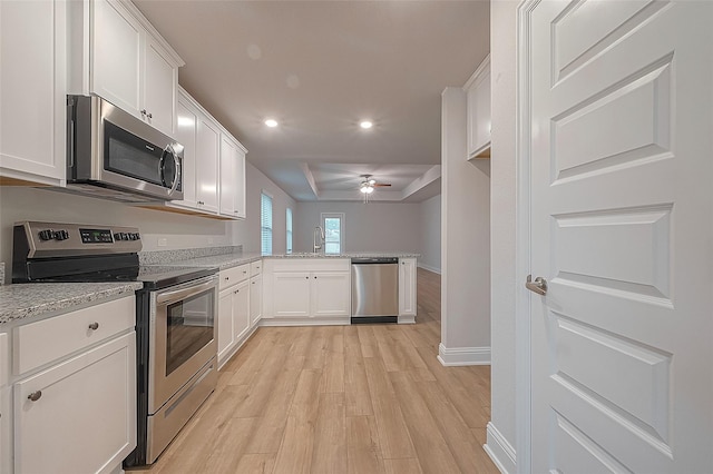 412 Bryan Way, Angleton, TX 77515 - kitchen with appliances with stainless steel finishes, a ceiling fan, a peninsula, light wood-style flooring, and white cabinetry