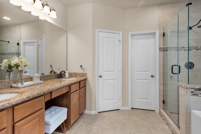 13607 Summer Hill Dr, Montgomery, TX 77356 - full bathroom featuring double vanity, a shower stall, tile patterned flooring, and baseboards