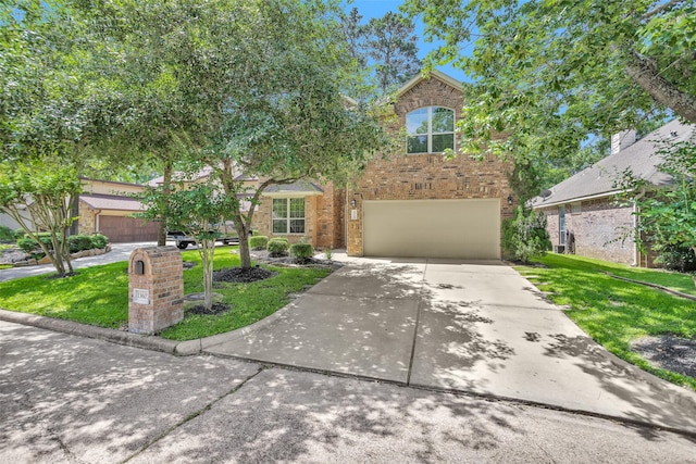 13607 Summer Hill Dr, Montgomery, TX 77356 - view of front of property featuring a front yard, concrete driveway, an attached garage, and brick siding