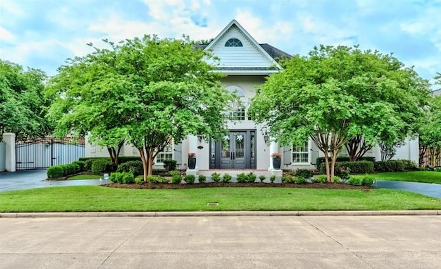 5065 Oakmont Dr, Beaumont, TX 77706 - view of front of property featuring a gate, a front yard, and french doors