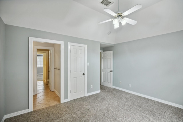 4011 N Water Iris Ct, Houston, TX 77059 - unfurnished bedroom featuring light colored carpet, baseboards, ceiling fan, vaulted ceiling, and light tile patterned floors