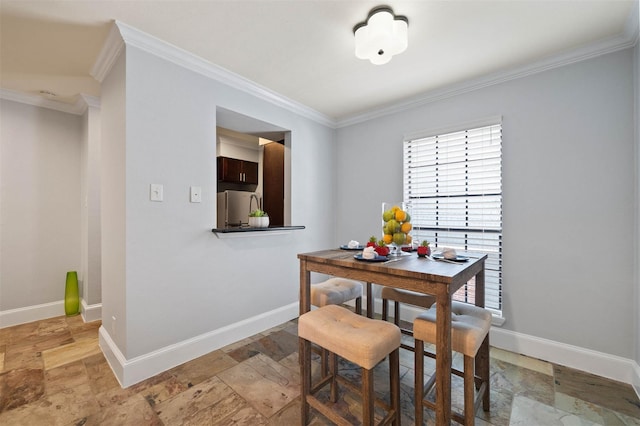 3402 Garrott St Unit 13, Houston, TX 77006 - dining space with stone tile floors, ornamental molding, healthy amount of natural light, and baseboards