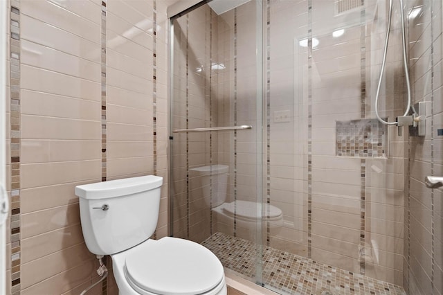 3402 Garrott St Unit 13, Houston, TX 77006 - bathroom featuring toilet and a shower stall