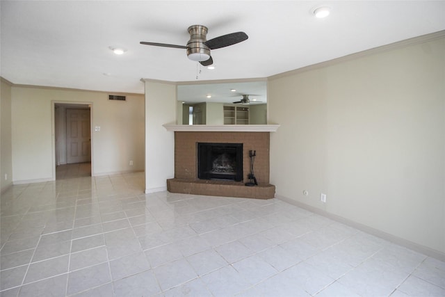 unfurnished living room featuring ceiling fan, light tile patterned floors, crown molding, a brick fireplace, and baseboards