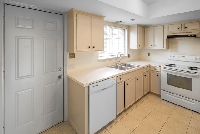 kitchen with white appliances, under cabinet range hood, a sink, and cream cabinets