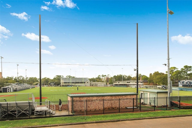 view of home's community featuring fence and an area for sports