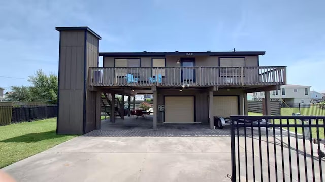 16631 Henry Morgan Rd, Jamaica Beach, TX 77554 - view of front of property with stairs, concrete driveway, an attached garage, and a wooden deck