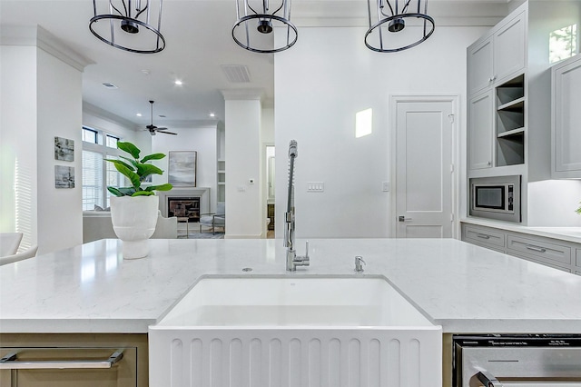2120 Blalock Rd Unit D, Houston, TX 77080 - kitchen with a sink, stainless steel appliances, ceiling fan, open floor plan, and a glass covered fireplace