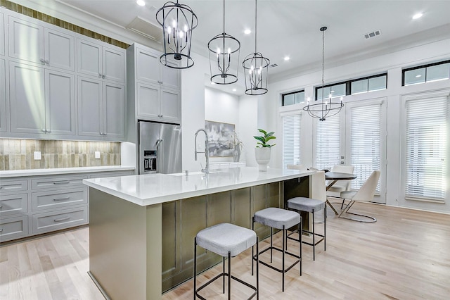 2120 Blalock Rd Unit D, Houston, TX 77080 - kitchen featuring high end refrigerator, a chandelier, a sink, light wood-type flooring, and light countertops