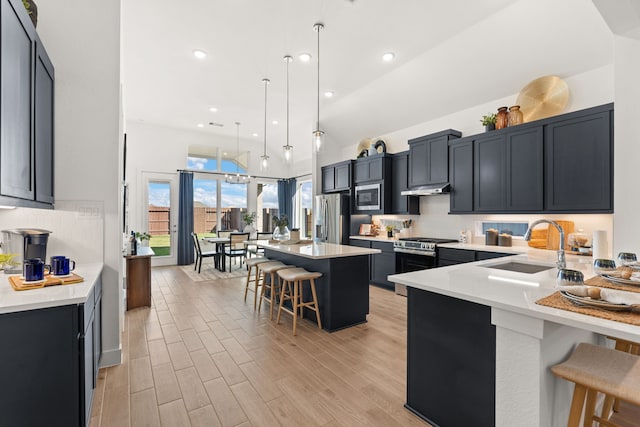 12027 Crooked Creek Ln, Santa Fe, TX 77510 - kitchen with stainless steel appliances, a kitchen breakfast bar, a sink, decorative backsplash, and light countertops