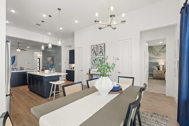 12027 Crooked Creek Ln, Santa Fe, TX 77510 - dining room with wood tiled floors, recessed lighting, a chandelier, and ceiling fan