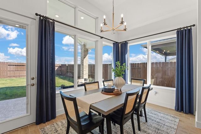 12027 Crooked Creek Ln, Santa Fe, TX 77510 - dining space featuring a chandelier, light wood-style flooring, and plenty of natural light