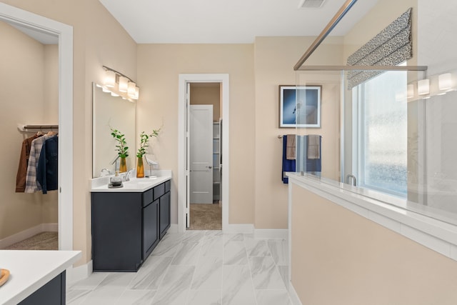 12027 Crooked Creek Ln, Santa Fe, TX 77510 - bathroom featuring vanity, baseboards, and marble look tile flooring