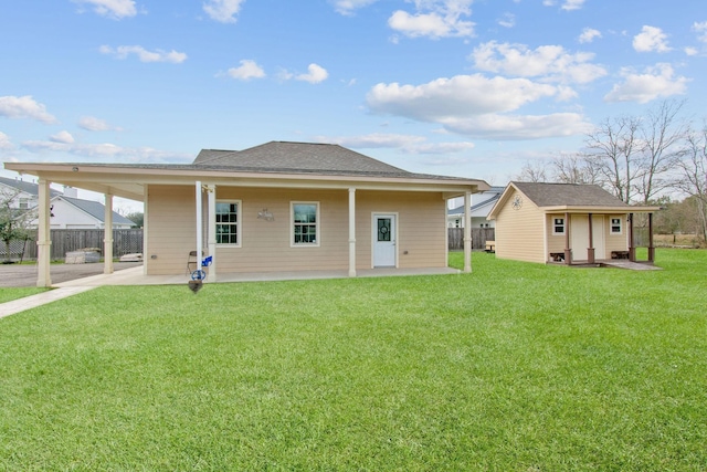 9436 Hufsmith Rd, Tomball, TX 77375 - back of property with a carport, an outdoor structure, a patio, and a shingled roof