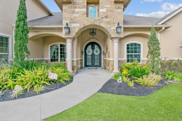9436 Hufsmith Rd, Tomball, TX 77375 - doorway to property with stone siding, stucco siding, and a shingled roof