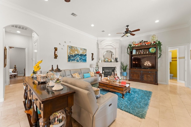 9436 Hufsmith Rd, Tomball, TX 77375 - living room featuring a ceiling fan, arched walkways, recessed lighting, a fireplace, and crown molding